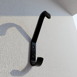 Coat hook mounted on a wall.