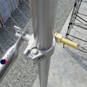 Scaffold joint showing a coupler with tilt pin securing tubes on a construction site.