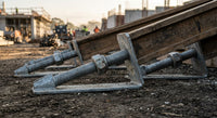 Adjustable base screw jacks carrying timber formwork bearers on levelled ground