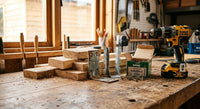 Angle brackets, screws and a drill on a workbench for DIY self-build projects