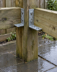 Hot-dip galvanised angle brackets bolted to an outdoor timber post joint